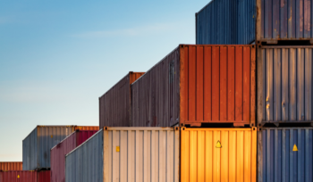 Stacked shipping containers illustrating supply route concentration risk in strategic foresight, Clarion Consulting