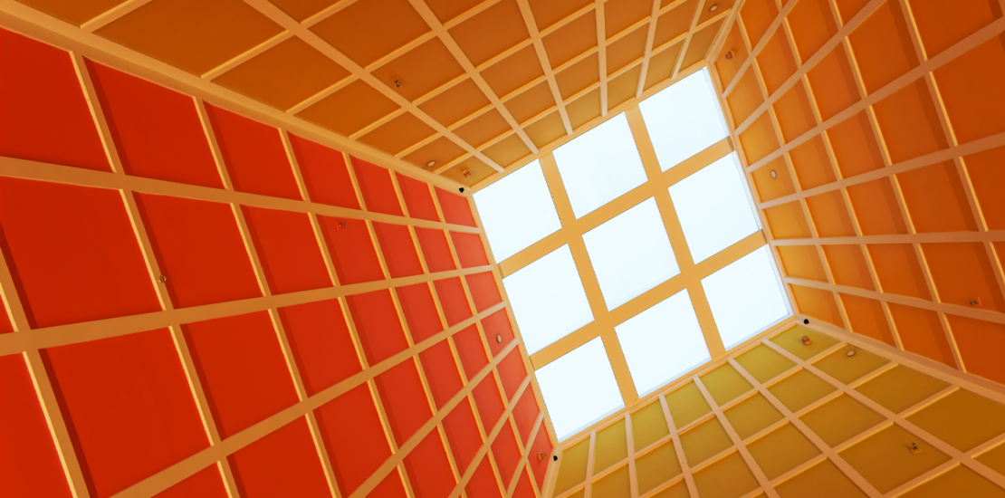 Looking up through a gridded ceiling skylight, illustrating the ceiling of a company's internal perspective, Clarion Consulting