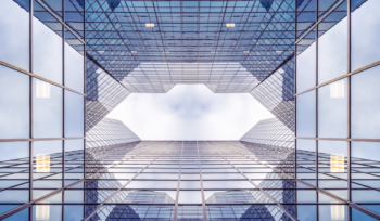 Glass office towers seen from below illustrating the governance gap in mid-sized Saudi companies, Clarion Consulting