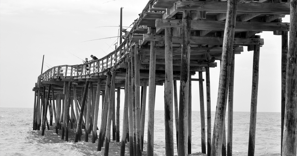Wooden pier on pilings illustrating the unstated assumptions beneath every business strategy, Clarion Consulting